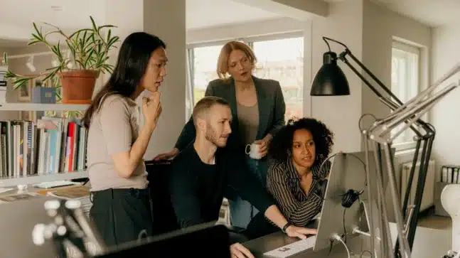 group of people in an office environment looking at a project