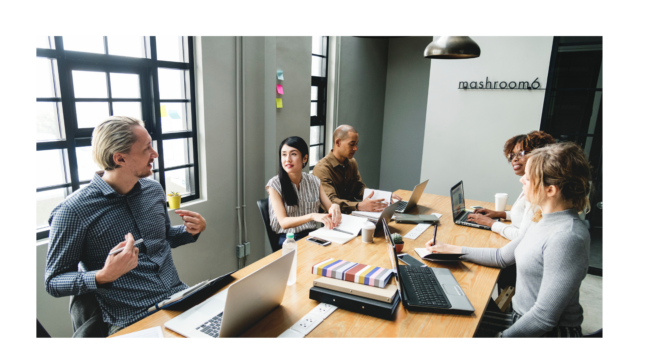 Image of four people around a table in an office setting